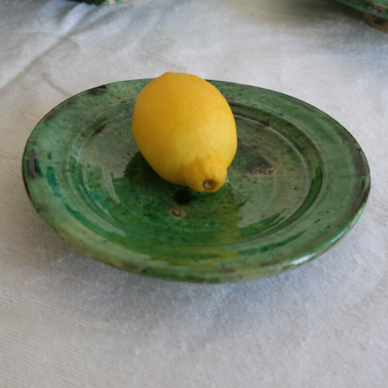 green earthenware saucer with lemon