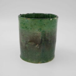 Small green earthenware cup